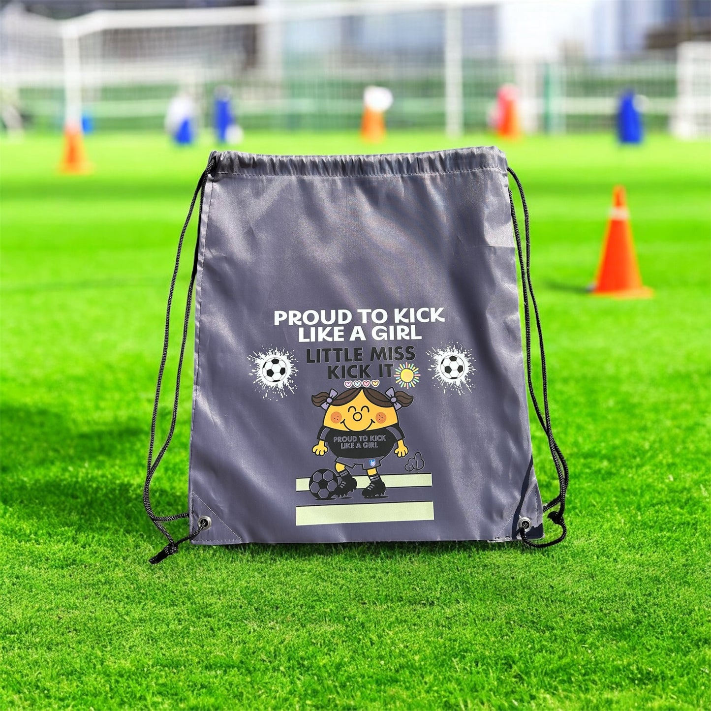 Drawstring bag with motivational text and graphics on a grass field
