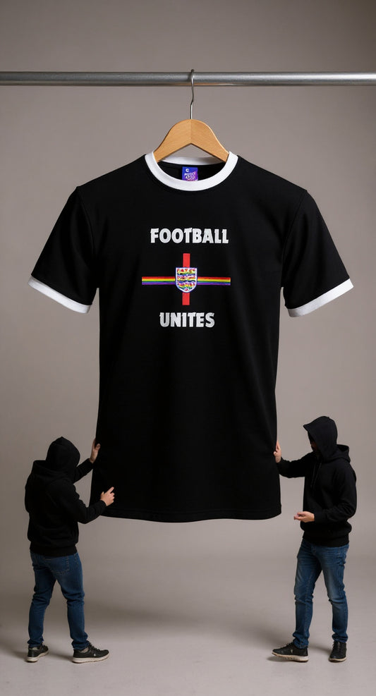 Pride Black t-shirt with 'Football Unites' text and rainbow design on a hanger, two people holding the shirt for scale.