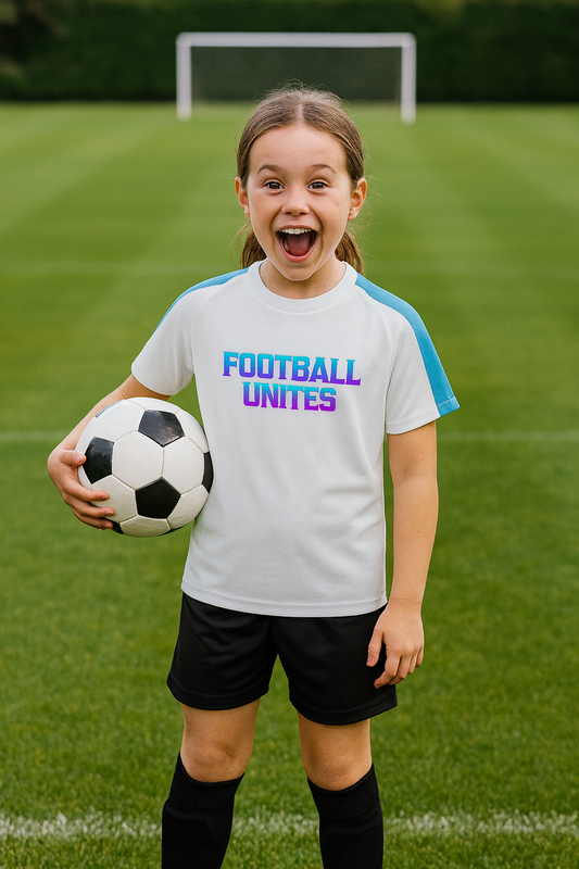 Young girl holding a soccer ball on a grass field with a goalpost in the background
